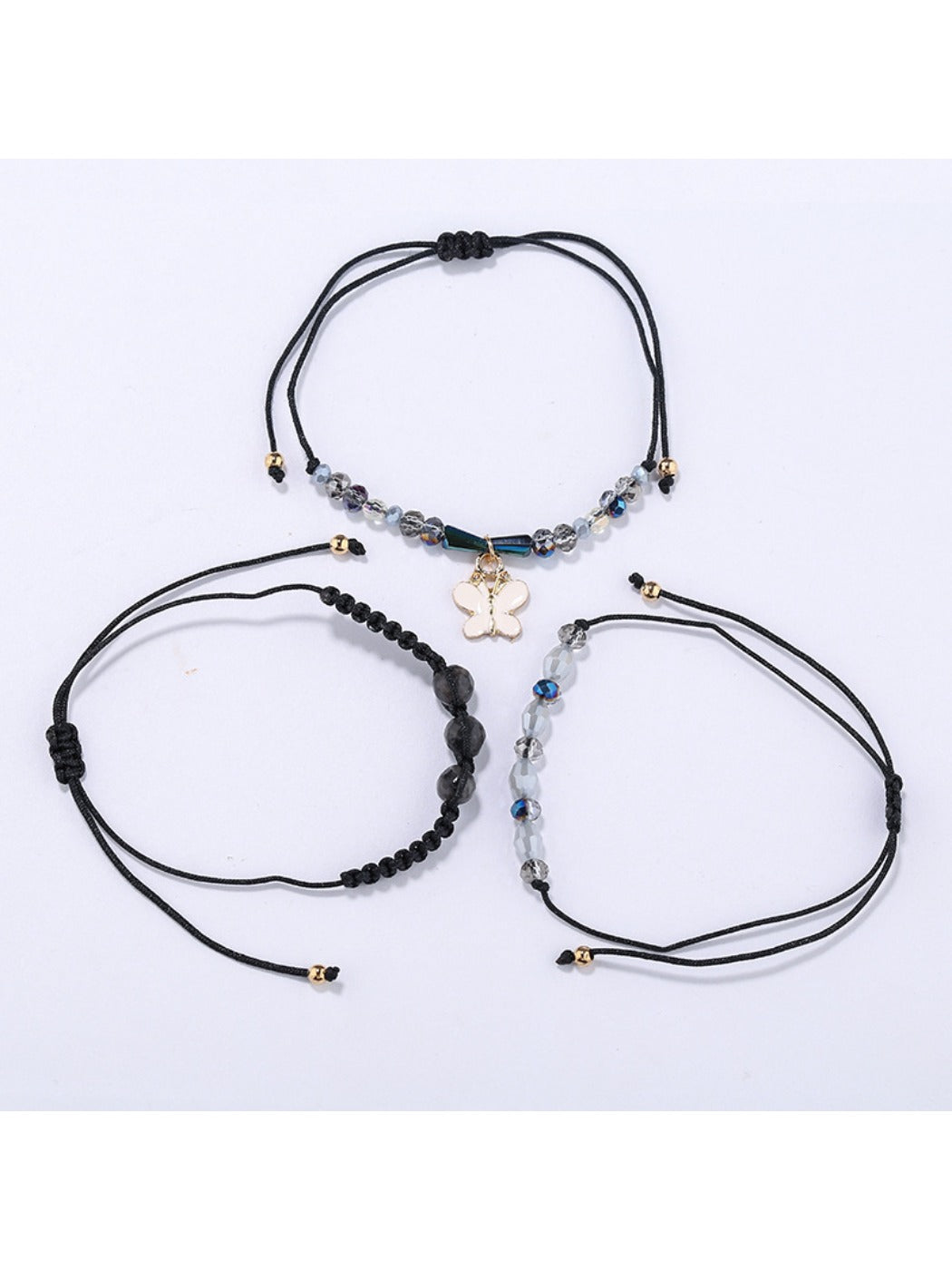 Lovra bracelet featuring butterfly pendant and small gold beads on wrist