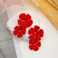 Earedge raffia drop earrings with floral pendant shown in natural light