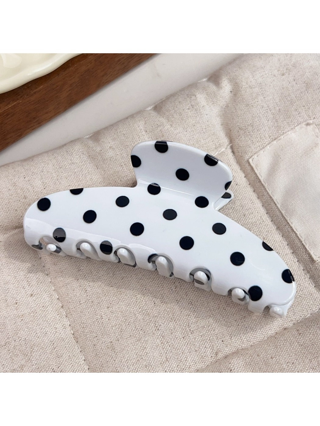 Beau polka dot half circle claw clip displayed on a white surface