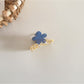 Beau fresh acetate flower hair clip with light reflecting off its smooth surface