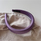 Purple wide edge headband displayed alongside other color options