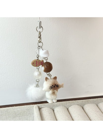 Both cat and fish keychains displayed side by side on a flat surface