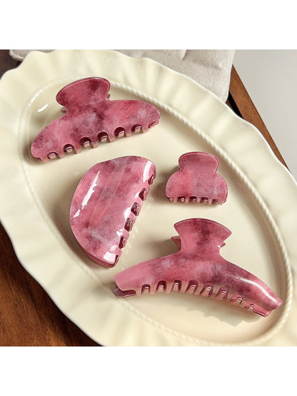 Beau pink ombre hair claw clip on white background showing gradient color