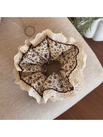 Gifty Retro Lace Floral Scrunchie held in hand showing size and delicate fabric design