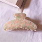 Beau chic tiny floral acetate claw clip styled in loose hair on model