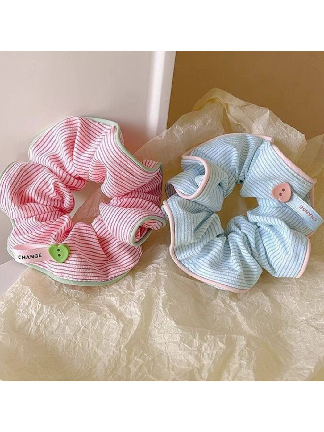 Gifty scrunchie displayed next to matching hair clips on a wooden surface