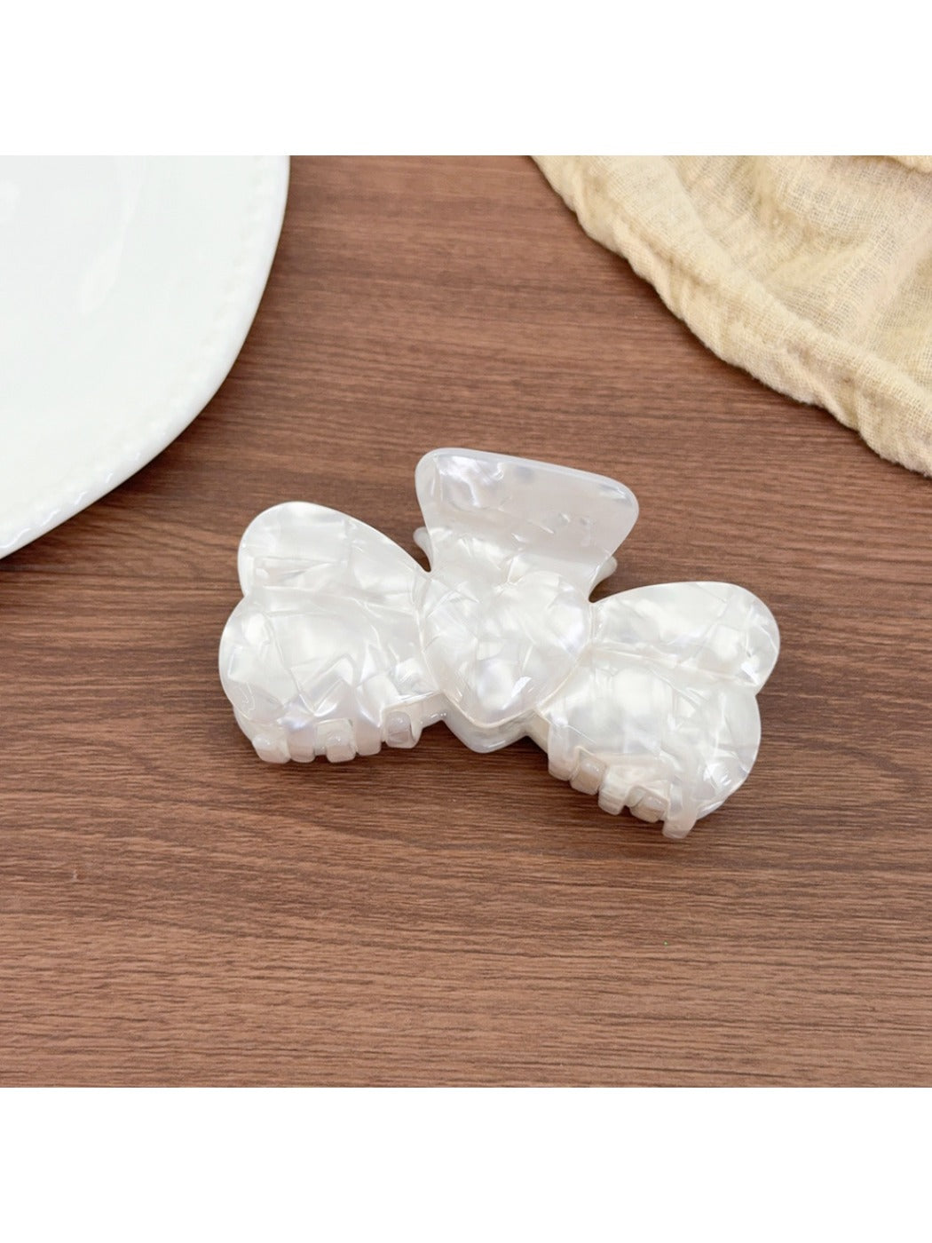 Beau bow shaped hair claw clip displayed on a white background