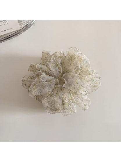 Side angle of Gifty floral print scrunchie highlighting fabric folds and print colors