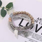 Lovra stackable bracelet layered with other bracelets on wrist