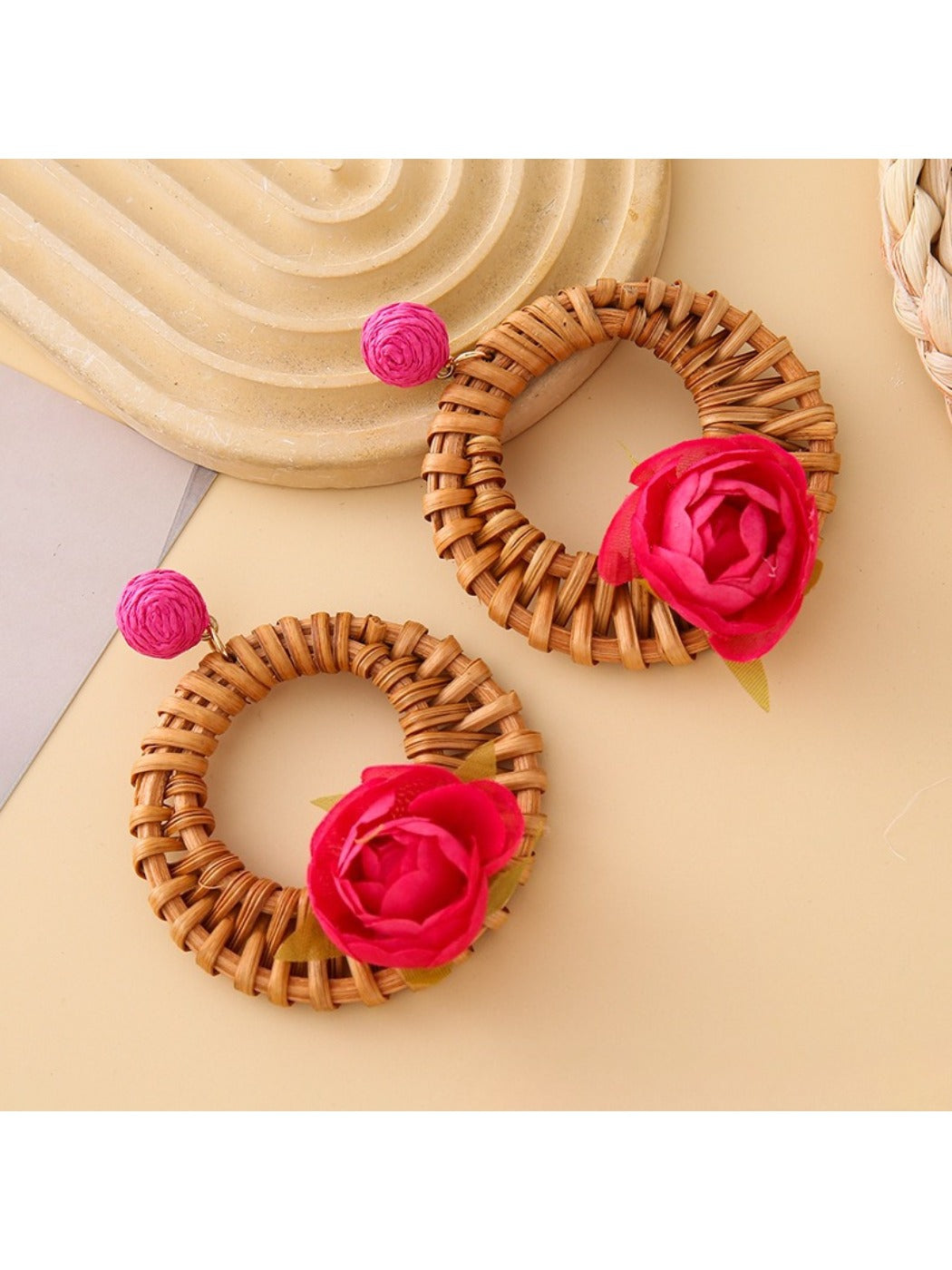 Vintage rattan woven circle earrings hanging on a jewelry stand