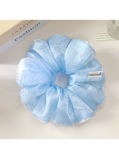 Gifty scrunchie styled in a ponytail on model with spring summer outfit
