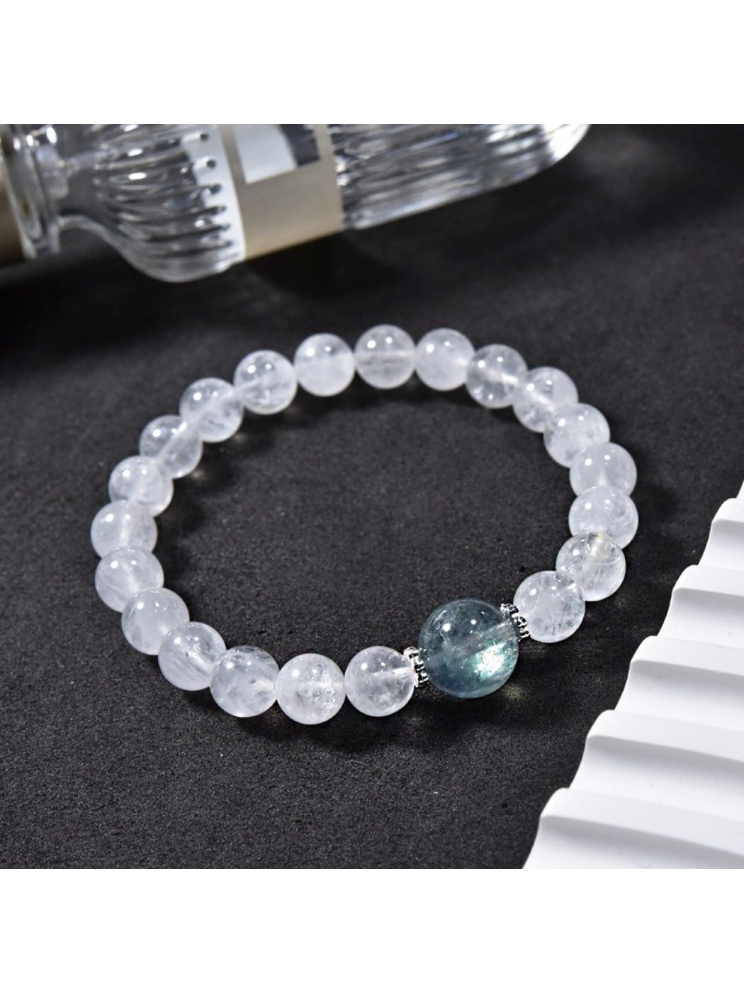Side view of Lovra clear quartz beaded bracelet showing bead texture