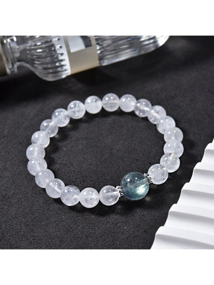 Side view of Lovra clear quartz beaded bracelet showing bead texture