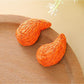 Pair of raffia water drop shaped stud earrings with natural fiber texture