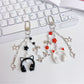 Minimalist over ear headphone pendant keychain in black with silver accents