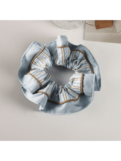 Gifty pastel scrunchie in multiple pastel shades arranged in a flat lay