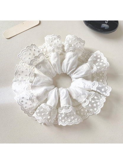 White lace trim scrunchie displayed with soft natural lighting