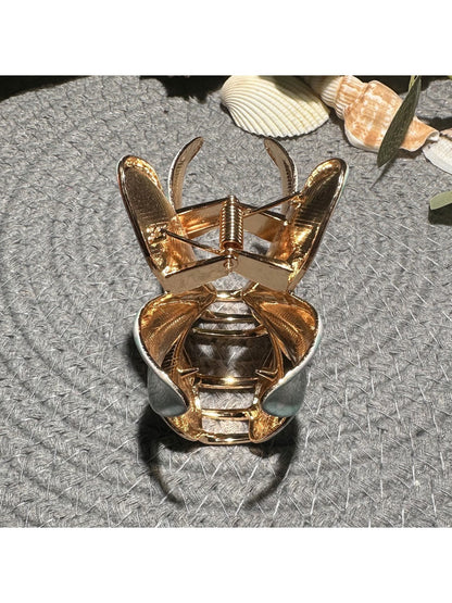 Close-up of Beau checkered flower hair clip showing textured petals and clasp