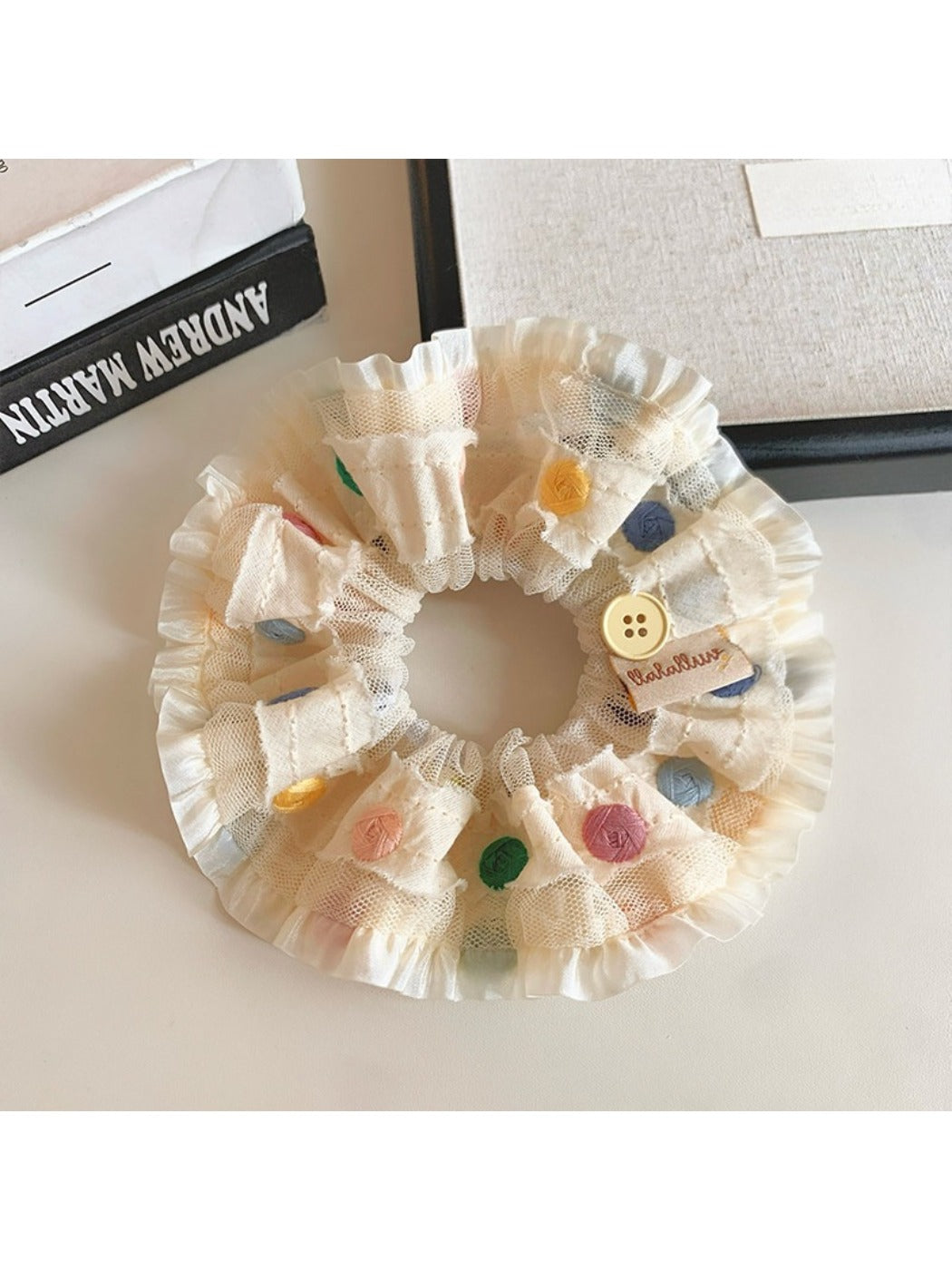 Side view of ruched scrunchie with bright polka dot pattern