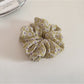 Gifty delicate daisy print scrunchie next to matching floral accessories
