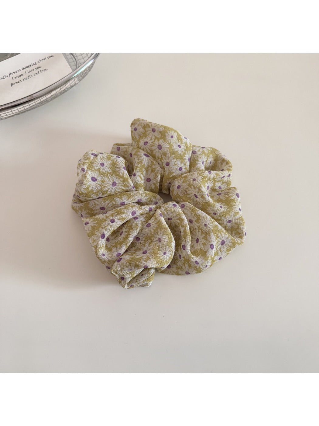 Gifty delicate daisy print scrunchie next to matching floral accessories
