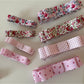Side view of Beau pink floral hair clip with metal clasp