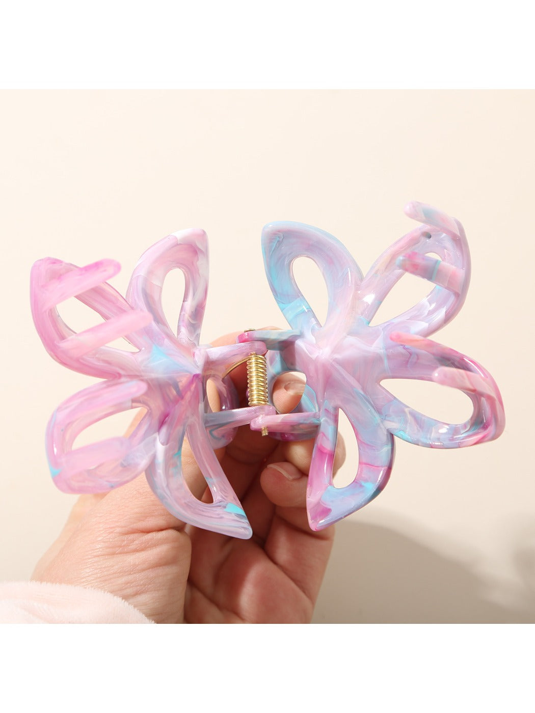 Beau hair clip clipped onto brown hair, displaying colorful flower design