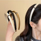 Model wearing Gifty satin headband styled with loose hair and casual outfit