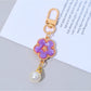 Keypus flower charm keychain displayed alongside other colorful accessories