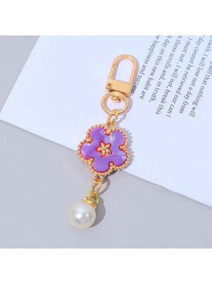 Keypus flower charm keychain displayed alongside other colorful accessories