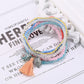 Lovra multi-row beaded bracelet with tassel styled with casual outfit