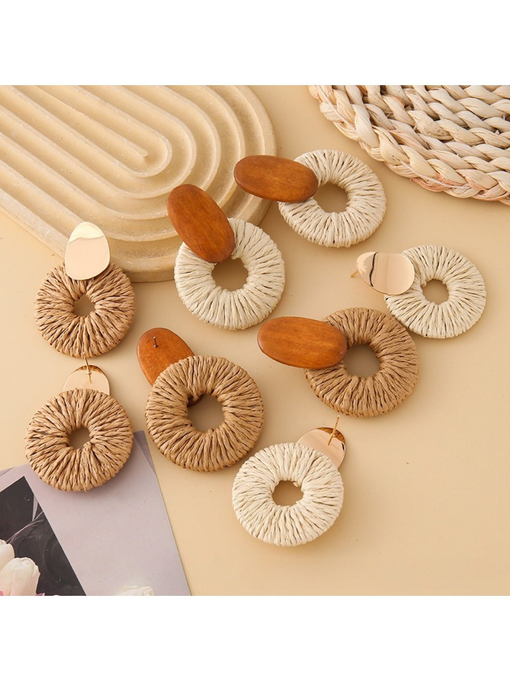 Pair of Earedge round drop earrings displayed on a black jewelry stand