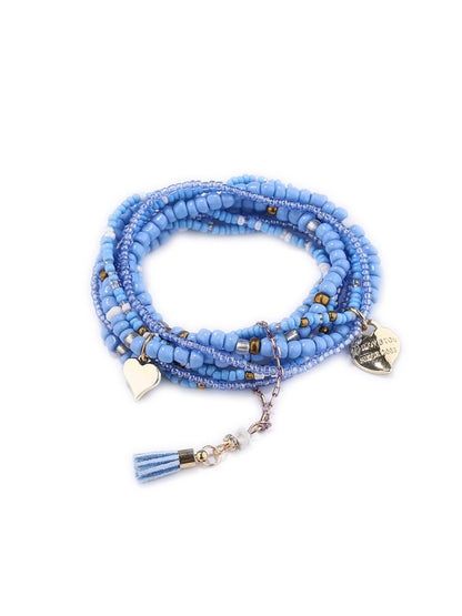 Lovra bracelet displayed on a hand with natural lighting emphasizing pendant shape