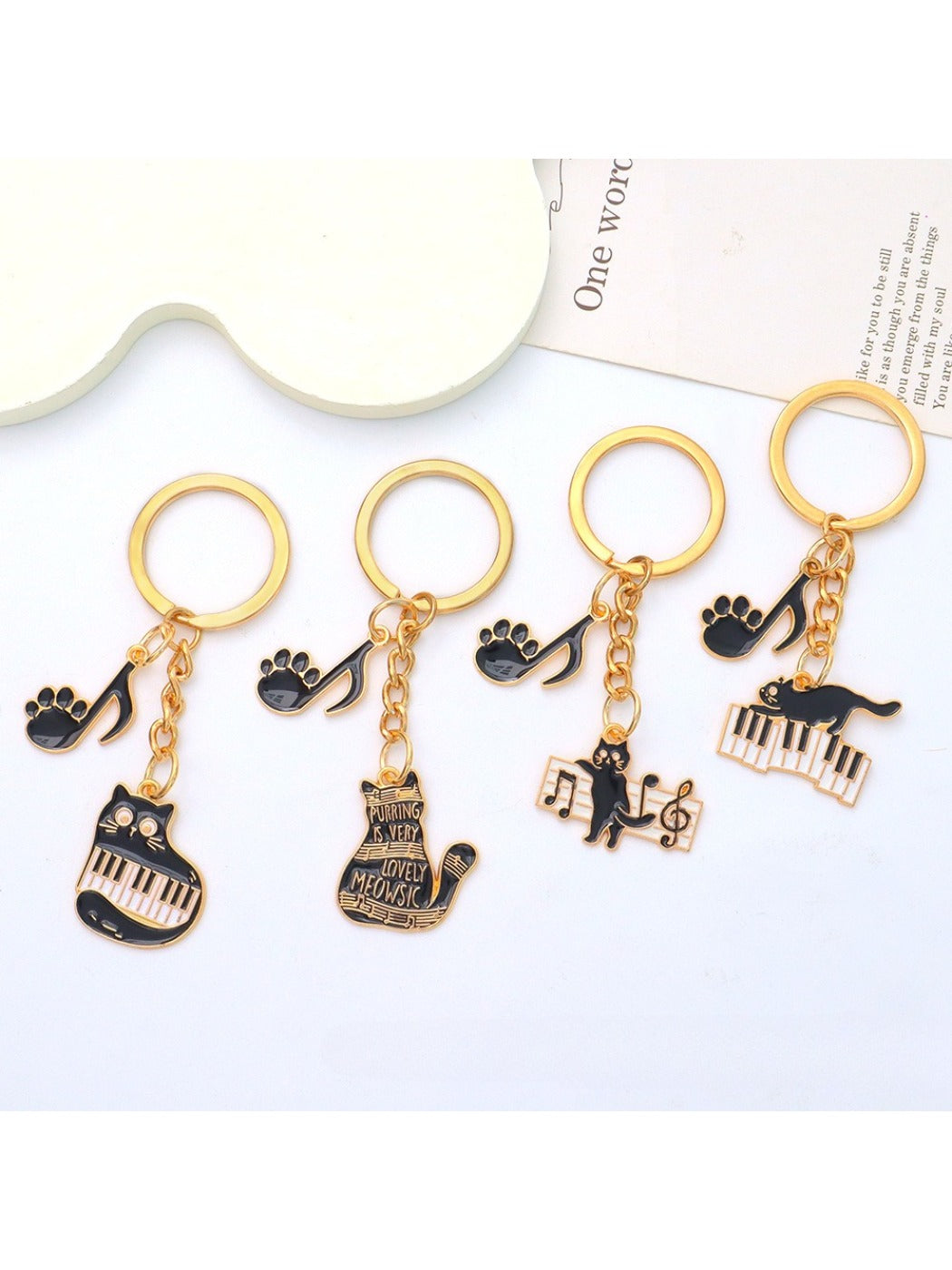 Side view of cartoon cat piano keychain showing keyring attachment