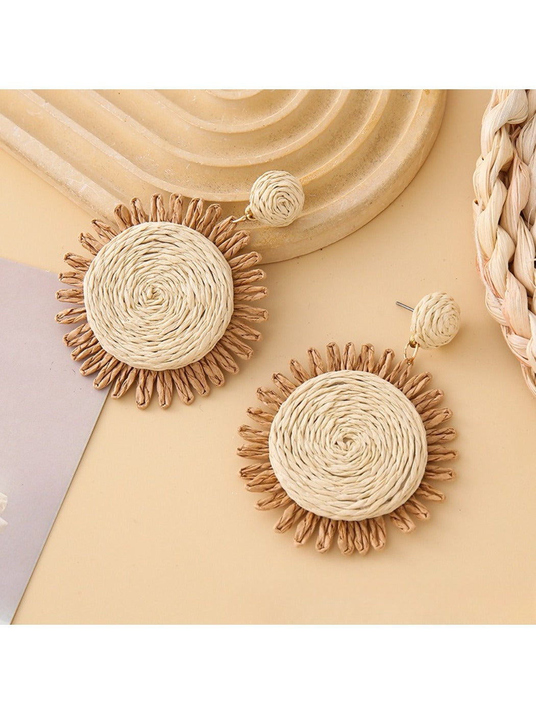 Earedge colorful raffia earrings hanging on a jewelry stand