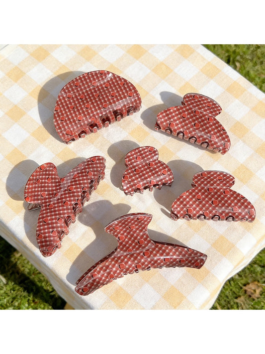 Beau plaid hair claw clip with red strawberry print on fabric