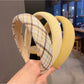 Yellow headband styled on a mannequin head with hair