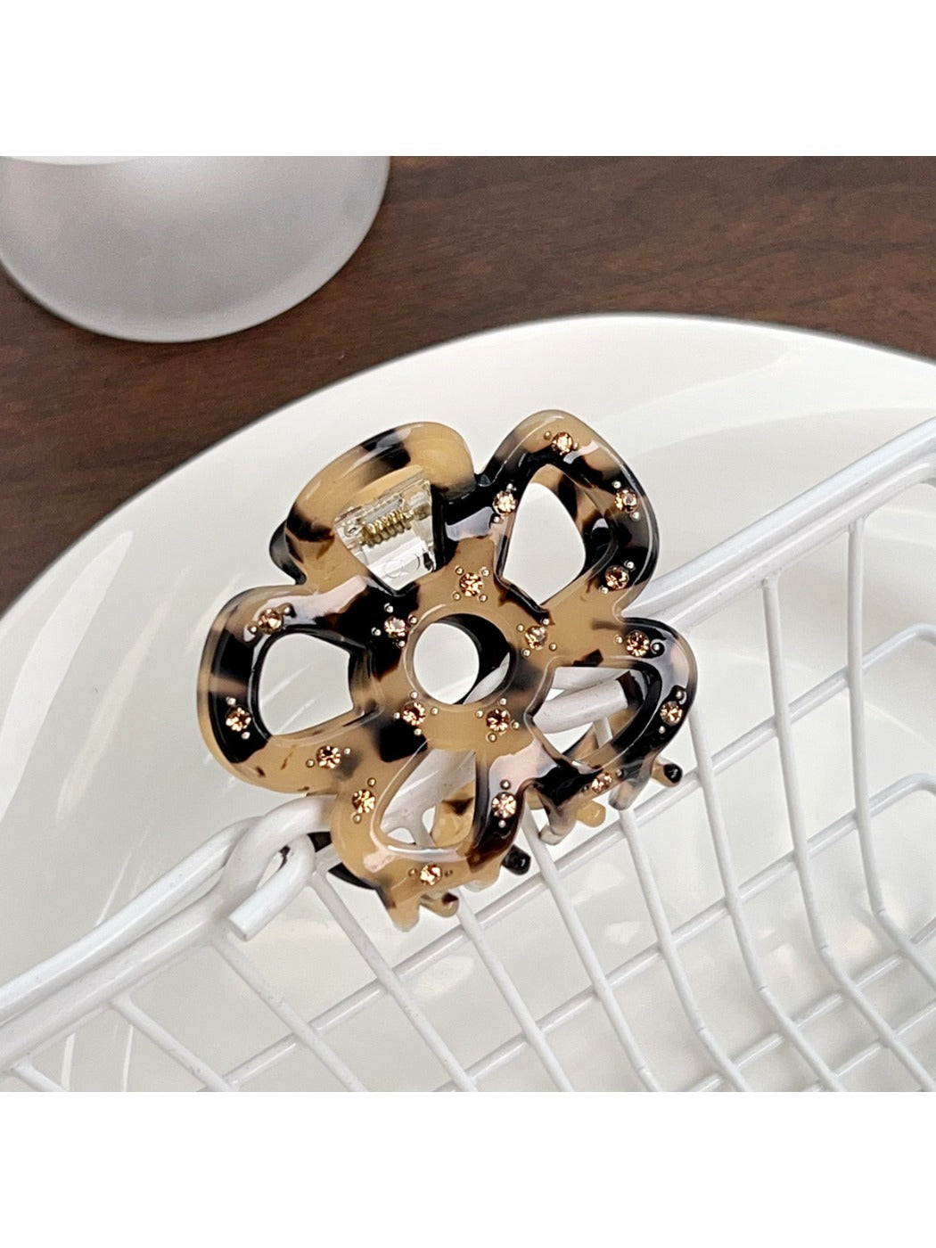 Beau openwork flower hair claw clip displayed with matching hair accessories
