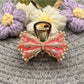 Beau hair clip worn in long brown hair, highlighting bow shape and size