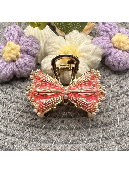 Beau hair clip worn in long brown hair, highlighting bow shape and size