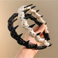 Side view of Gifty polka dot headband on model's head