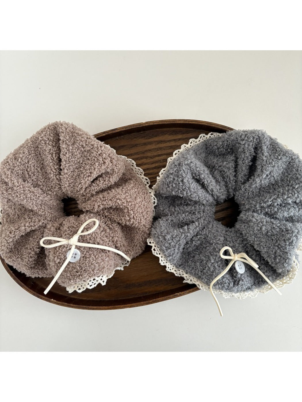 Top view of white lace bow tie scrunchie showing delicate lace pattern