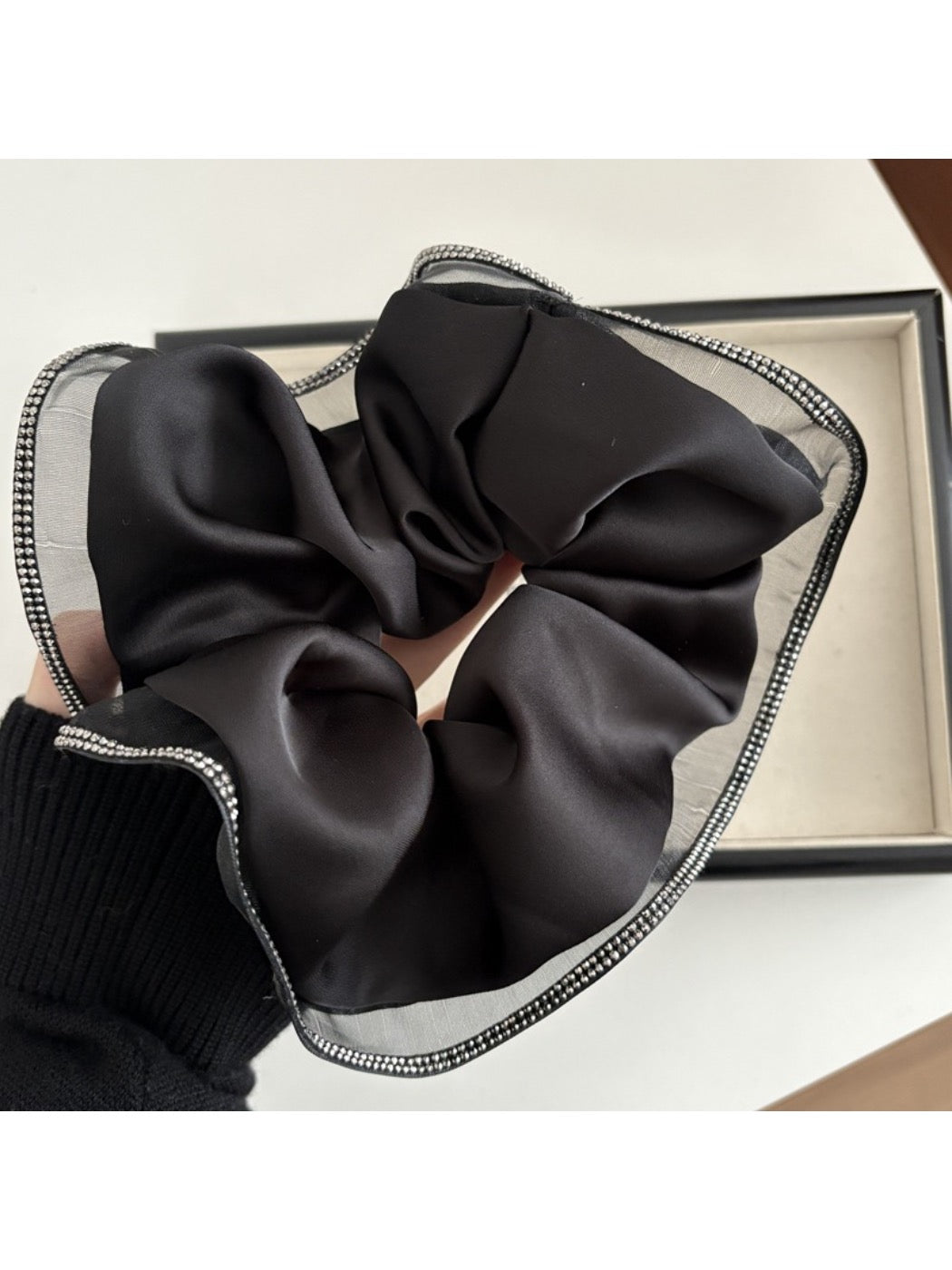 Gifty scrunchie displayed alongside matching minimalist accessories on a light surface