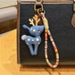 Keypus deer charm keychain shown from the back with smooth enamel finish