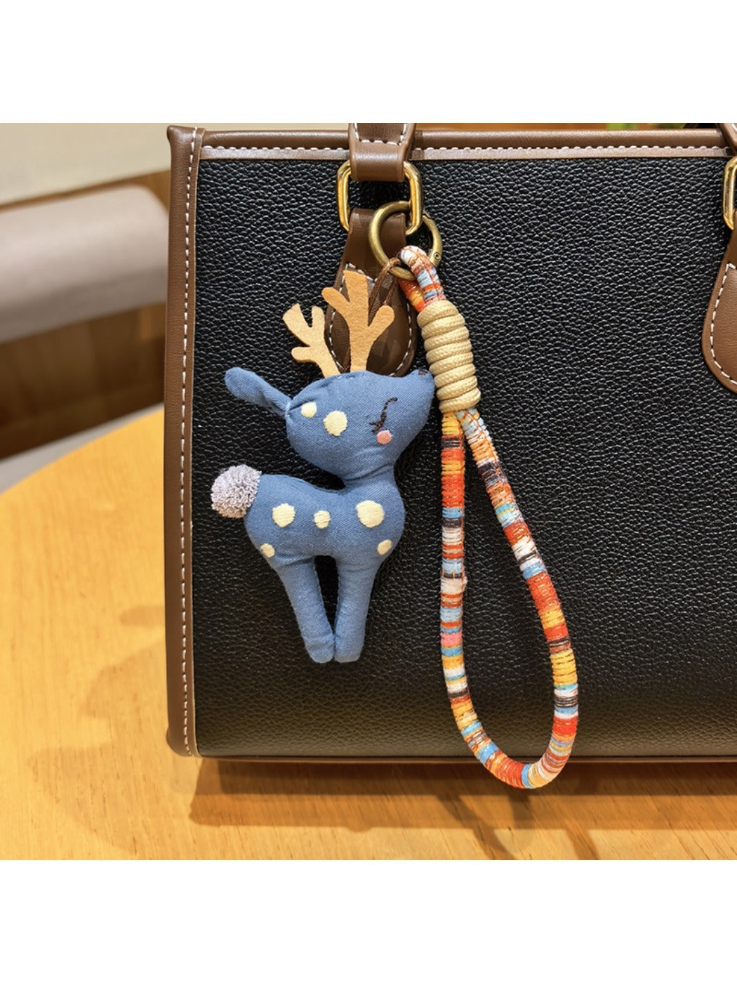 Keypus deer charm keychain shown from the back with smooth enamel finish