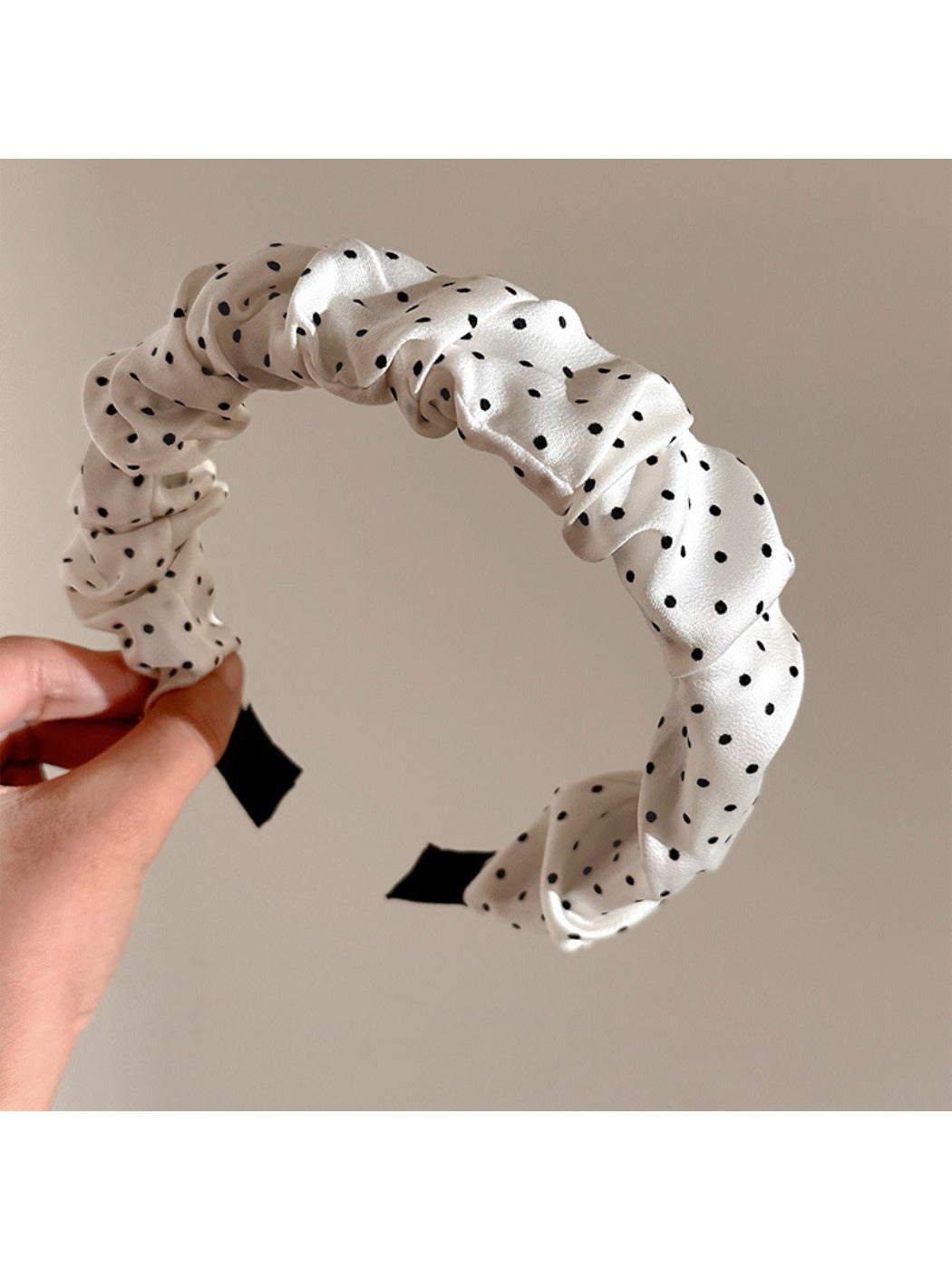 Model wearing Gifty pleated polka dot headband styled with casual outfit