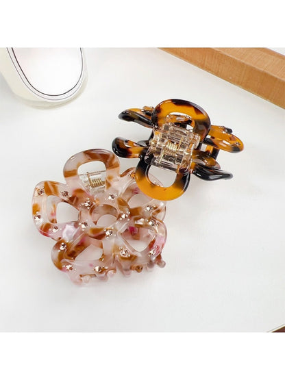 Beau hair claw clip displayed on a wooden surface with natural lighting