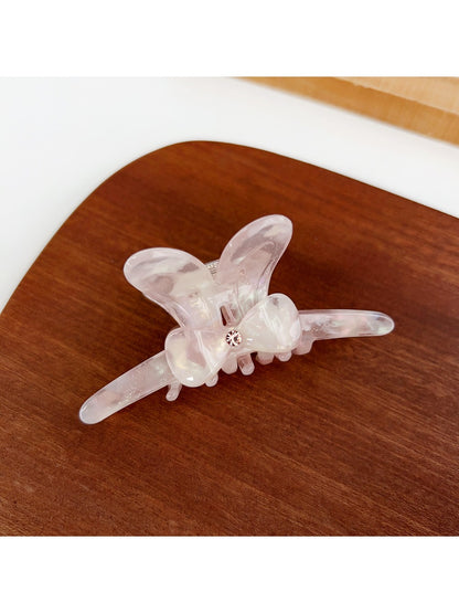 Beau bow hair claw clip displayed with packaging box in background