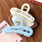 Close-up of Beau gold paperclip claw clip showing hollow design and clasp mechanism