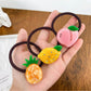 Yellow hair tie decorated with a lemon slice charm